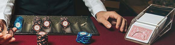 dealer with blackjack cards and chips