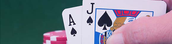 a hand of an Ace & J