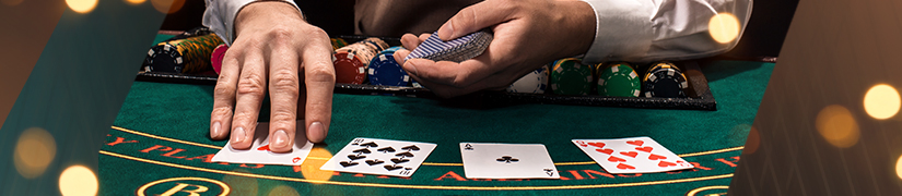The hand of a dealer playing a live table game in new zealand